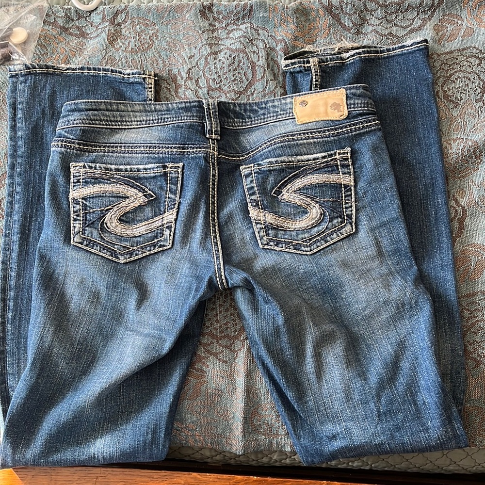 Silver jeans.  Good condition, minimal fraying on back hem.